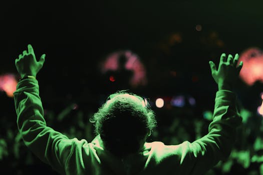 A Person in Long Sleeve Shirt Lifting Hands Up